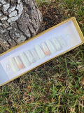 Long coffin press-on nail set with white to peach ombre, silver glitter and butterfly embellishment in gold gift box