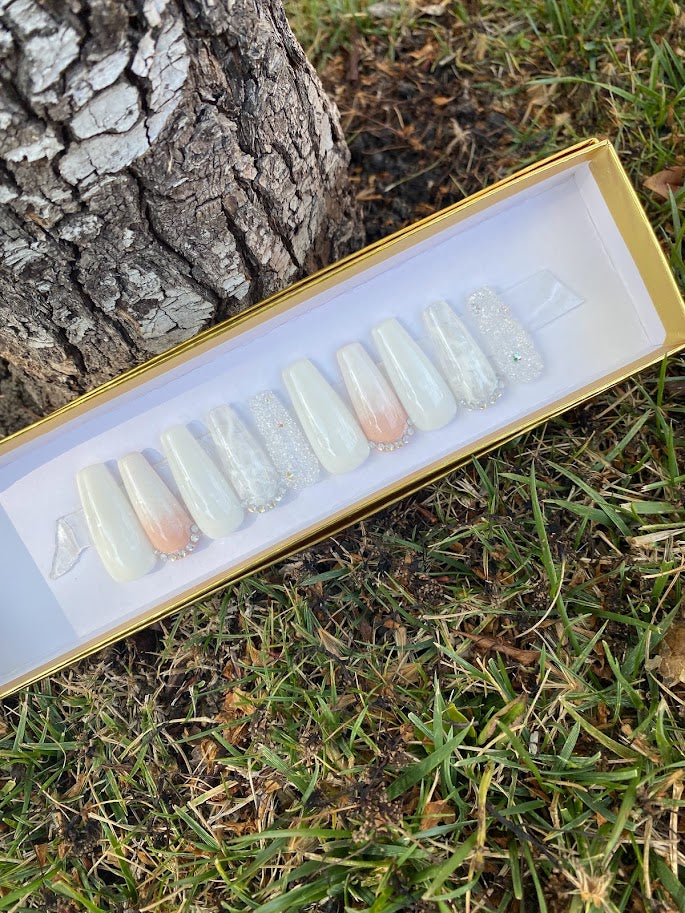Long coffin press-on nail set with white to peach ombre, silver glitter and butterfly embellishment in gold gift box