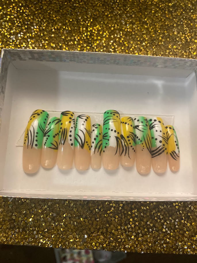 Tropical green and yellow almond press-on nail set with black botanical leaf nail art