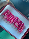 Hot pink glitter Hello Kitty press-on nail set with 3D character charms and rhinestone accents